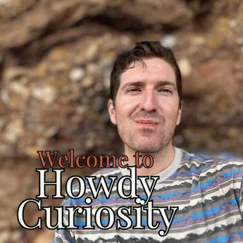 Blake Reichenbach the owner of Howdy Curiosity with the text Welcome to Howdy Curiosity overlaying the image